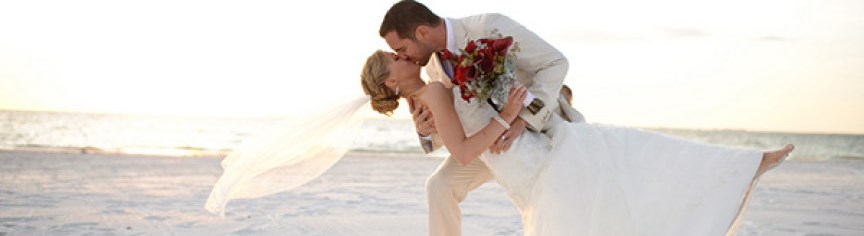 Newly Wed kissing on beach